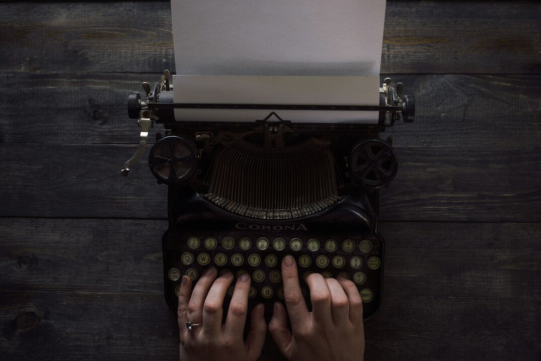 writer typing on old typewriter